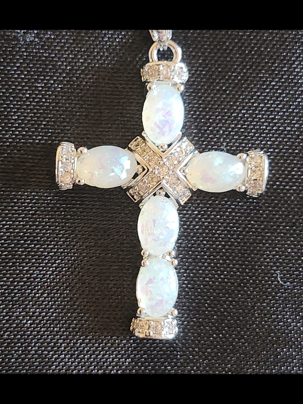 White fire opal cross necklace on silver necklace w/ clasp